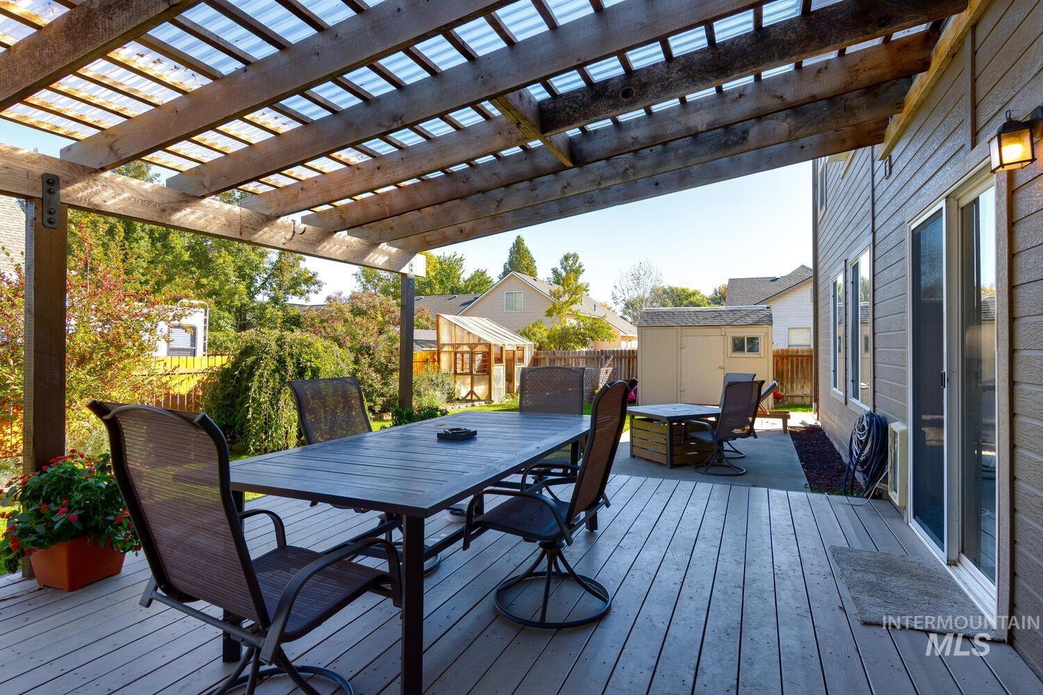 4428 West Campfire Street Meridian, ID 83646 - Photo 41 of 46 Wooden terrace with outdoor dining area, a shed, a fenced backyard, and a pergola