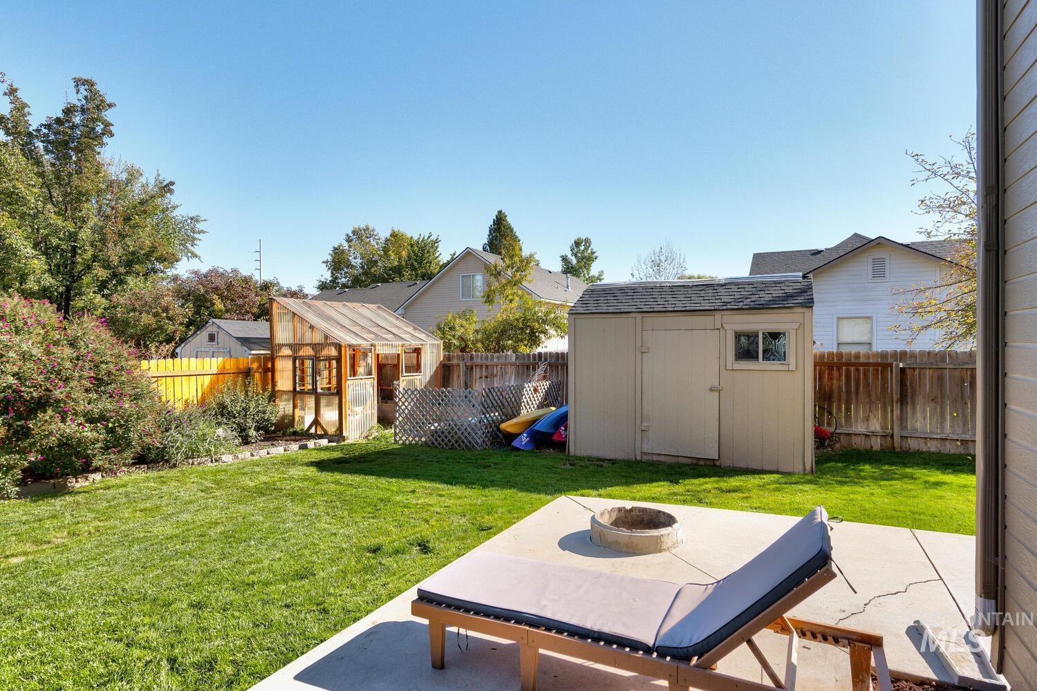 4428 West Campfire Street Meridian, ID 83646 - Photo 43 of 46 Fenced backyard with a storage shed, an outdoor fire pit, and a patio area