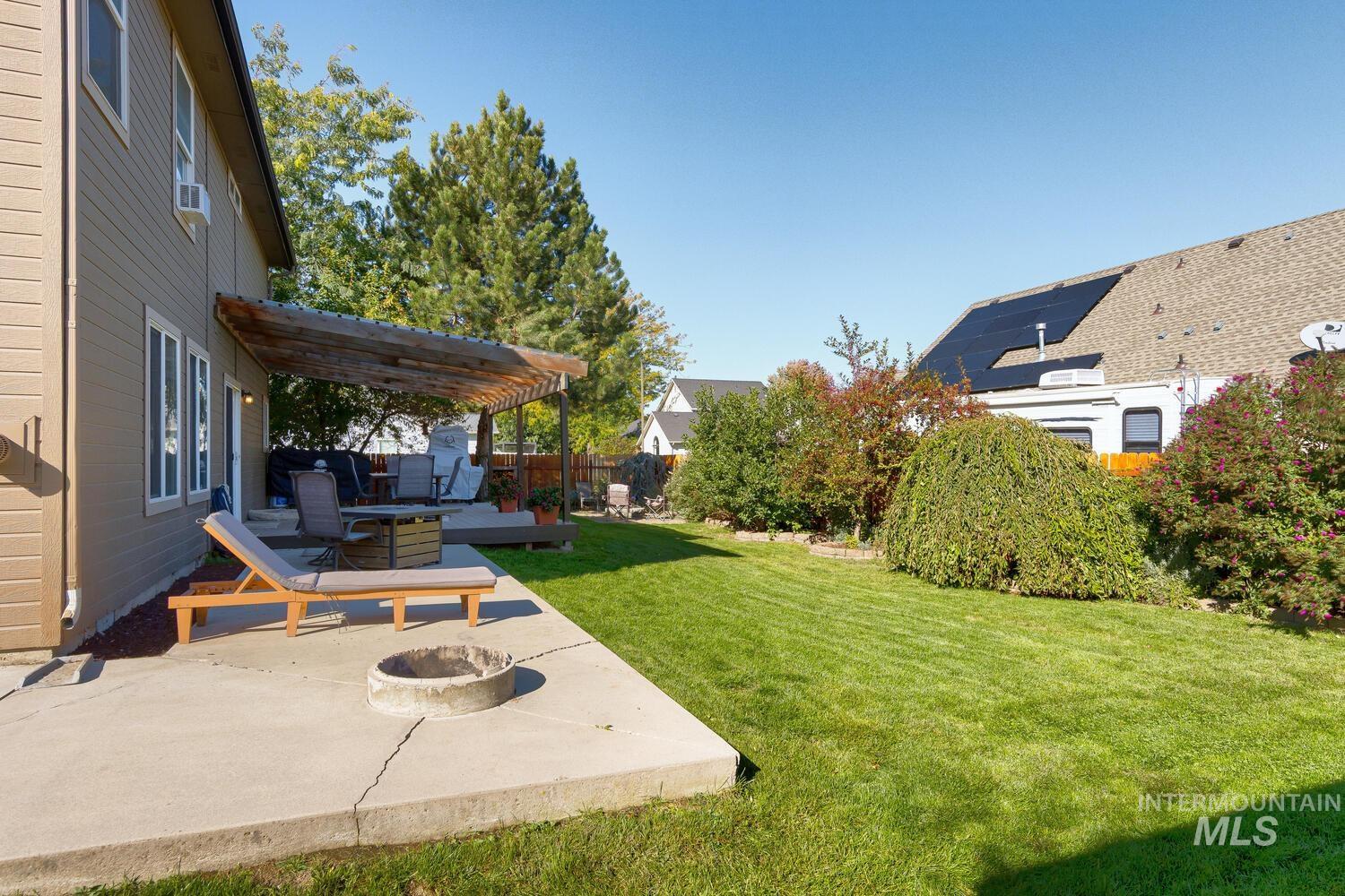 4428 West Campfire Street Meridian, ID 83646 - Photo 44 of 46 View of yard featuring an outdoor fire pit, a patio, and a wooden deck