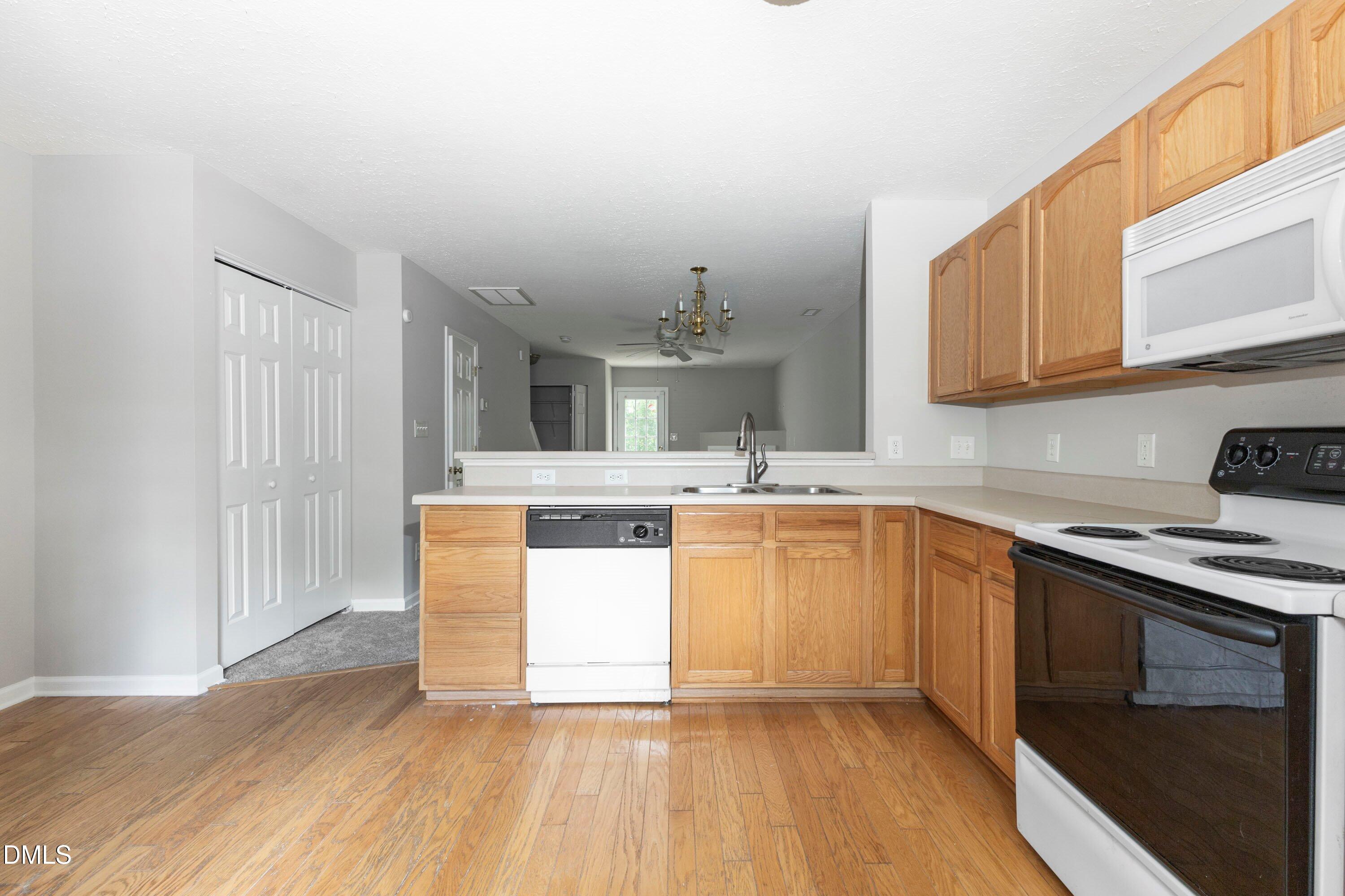 3358 Tarleton West Durham, NC 27713 - Photo 7 of 23 a kitchen with granite countertop a sink stove and cabinets