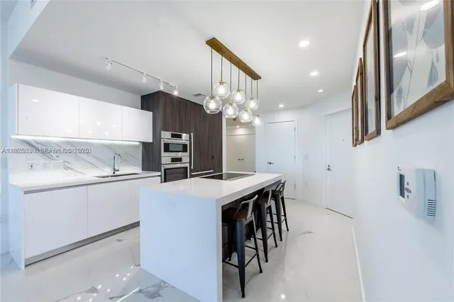a kitchen with cabinets a sink and appliances