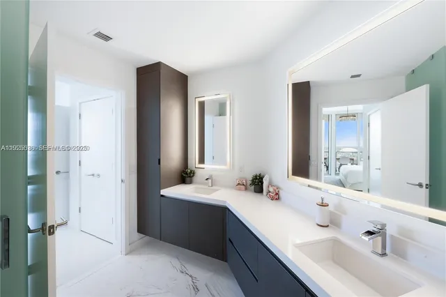 a bathroom with a double vanity sink mirror and double