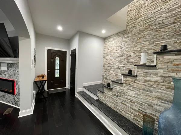 a living room with fireplace furniture and a flat screen tv