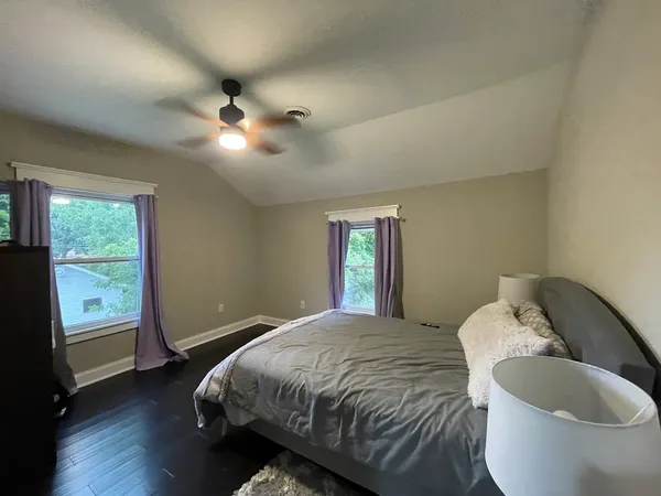 a bedroom with a bed and a large window