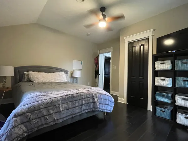 a bedroom with a bed and a chandelier