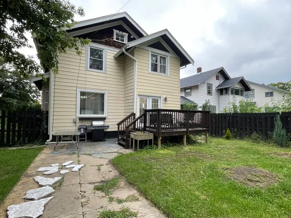 a view of a house with a backyard and sitting area