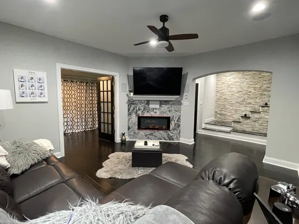 a living room with furniture fireplace and a flat screen tv