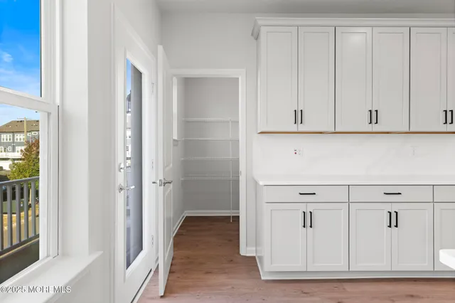 a view of a kitchen with white cabinets