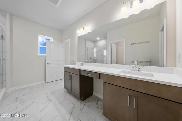 a bathroom with double sink and a mirror
