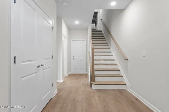 a view of a hallway with wooden floor and entryway
