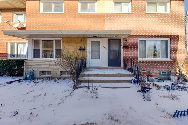 a front view of a house with outdoor seating