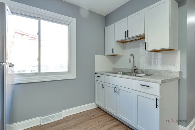 a kitchen with stainless steel appliances granite countertop a sink and wooden cabinets
