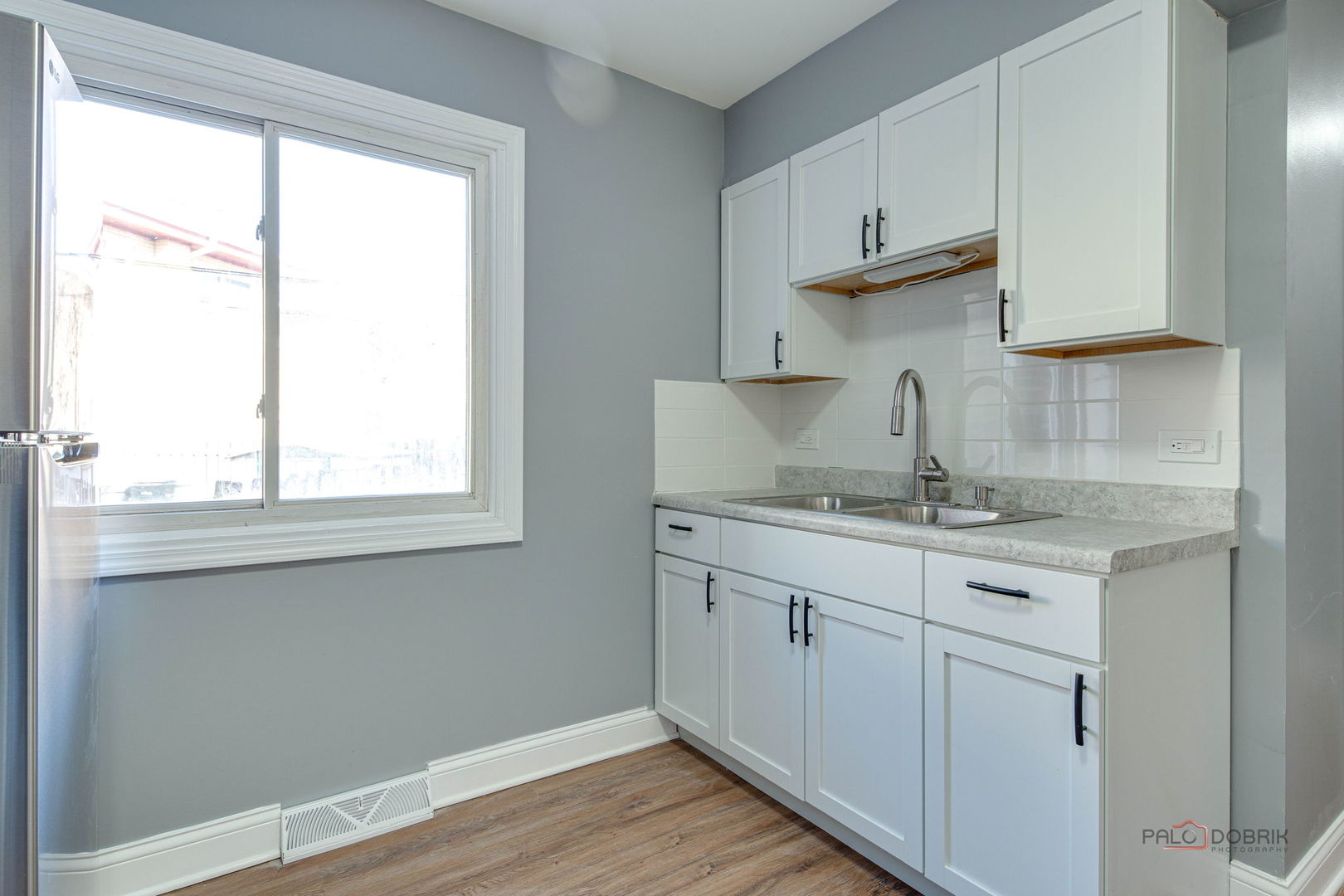 9463 Niles Center Road, Unit E Skokie, IL 60076 - Photo 12 of 30 a kitchen with stainless steel appliances granite countertop a sink and wooden cabinets