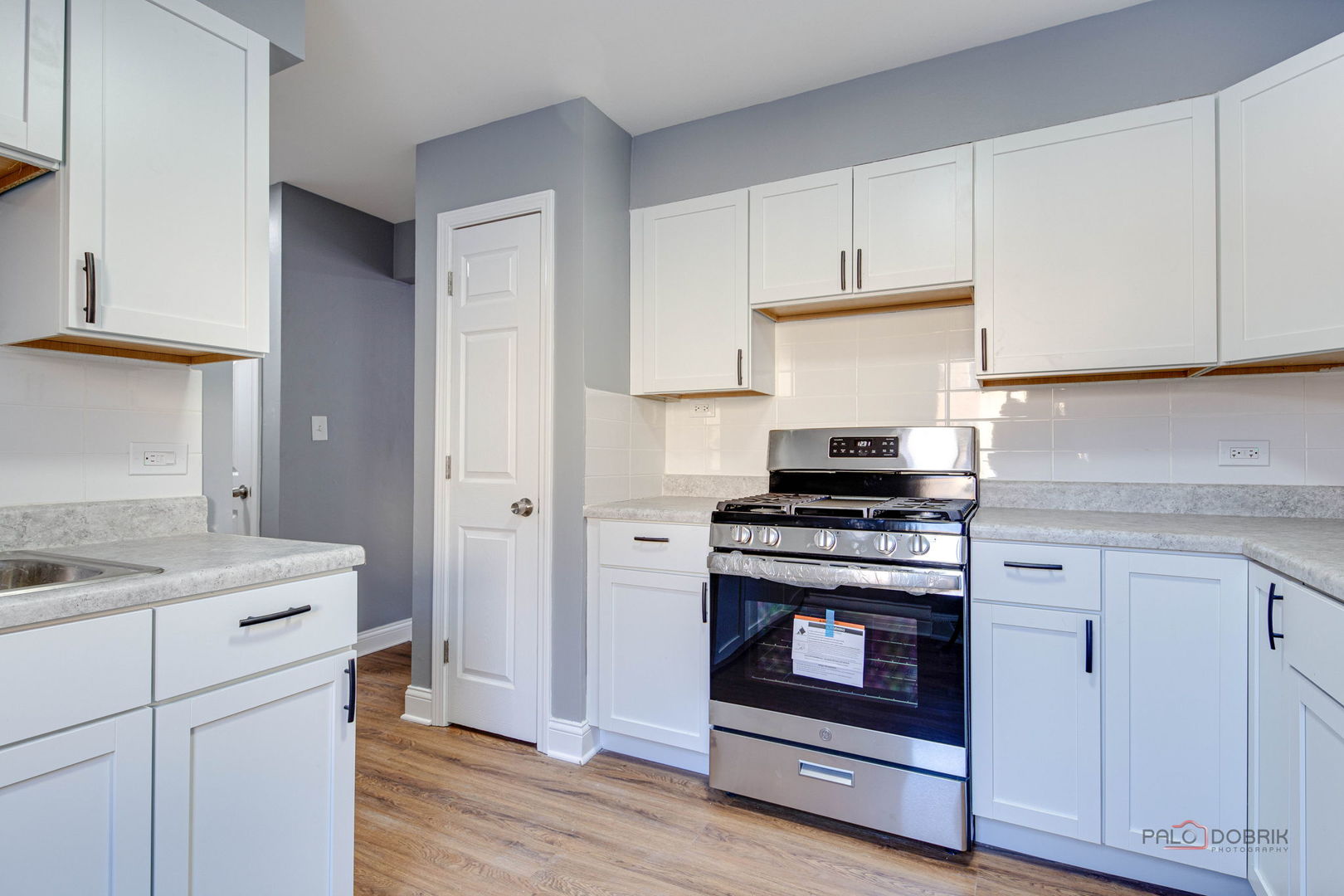 9463 Niles Center Road, Unit E Skokie, IL 60076 - Photo 13 of 30 a kitchen with a stove and a sink