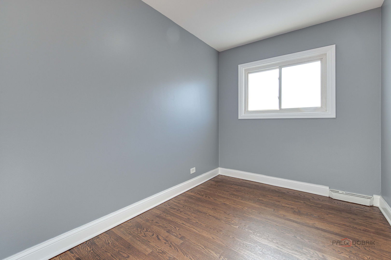 9463 Niles Center Road, Unit E Skokie, IL 60076 - Photo 17 of 30 wooden floor in an empty room with a window