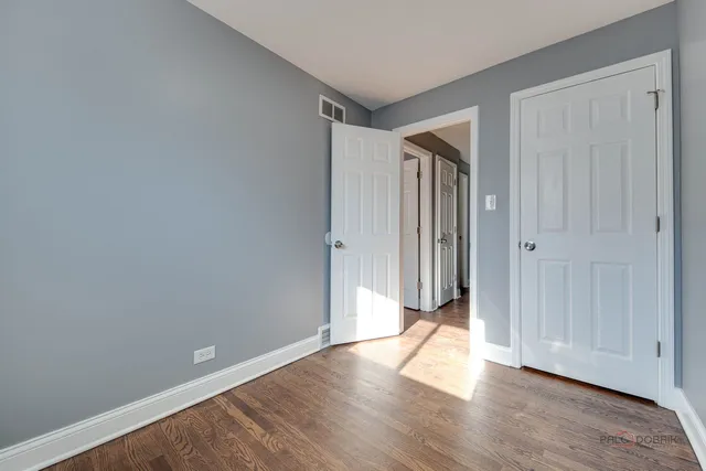 a view of a livingroom with wooden floor and closet area