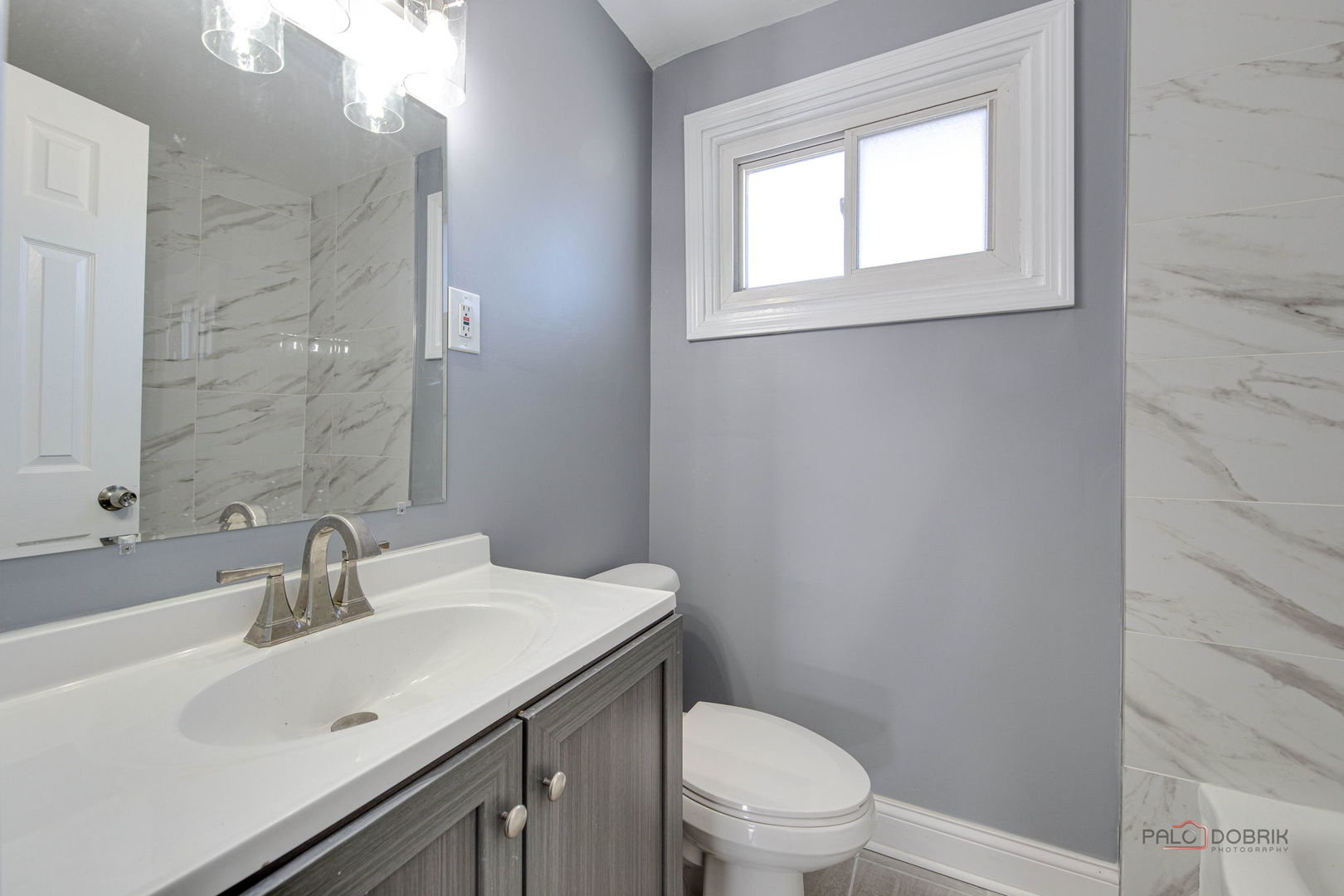 9463 Niles Center Road, Unit E Skokie, IL 60076 - Photo 19 of 30 a bathroom with a sink a toilet and shower