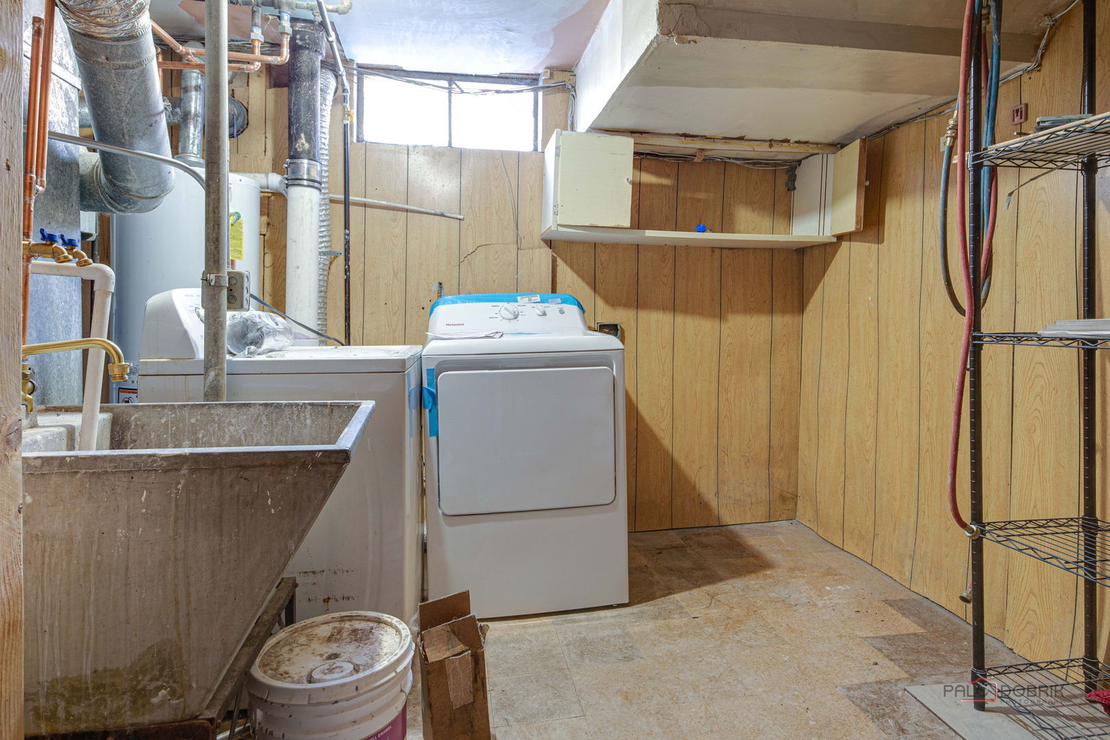 9463 Niles Center Road, Unit E Skokie, IL 60076 - Photo 27 of 30 a room with water heater and a wooden door