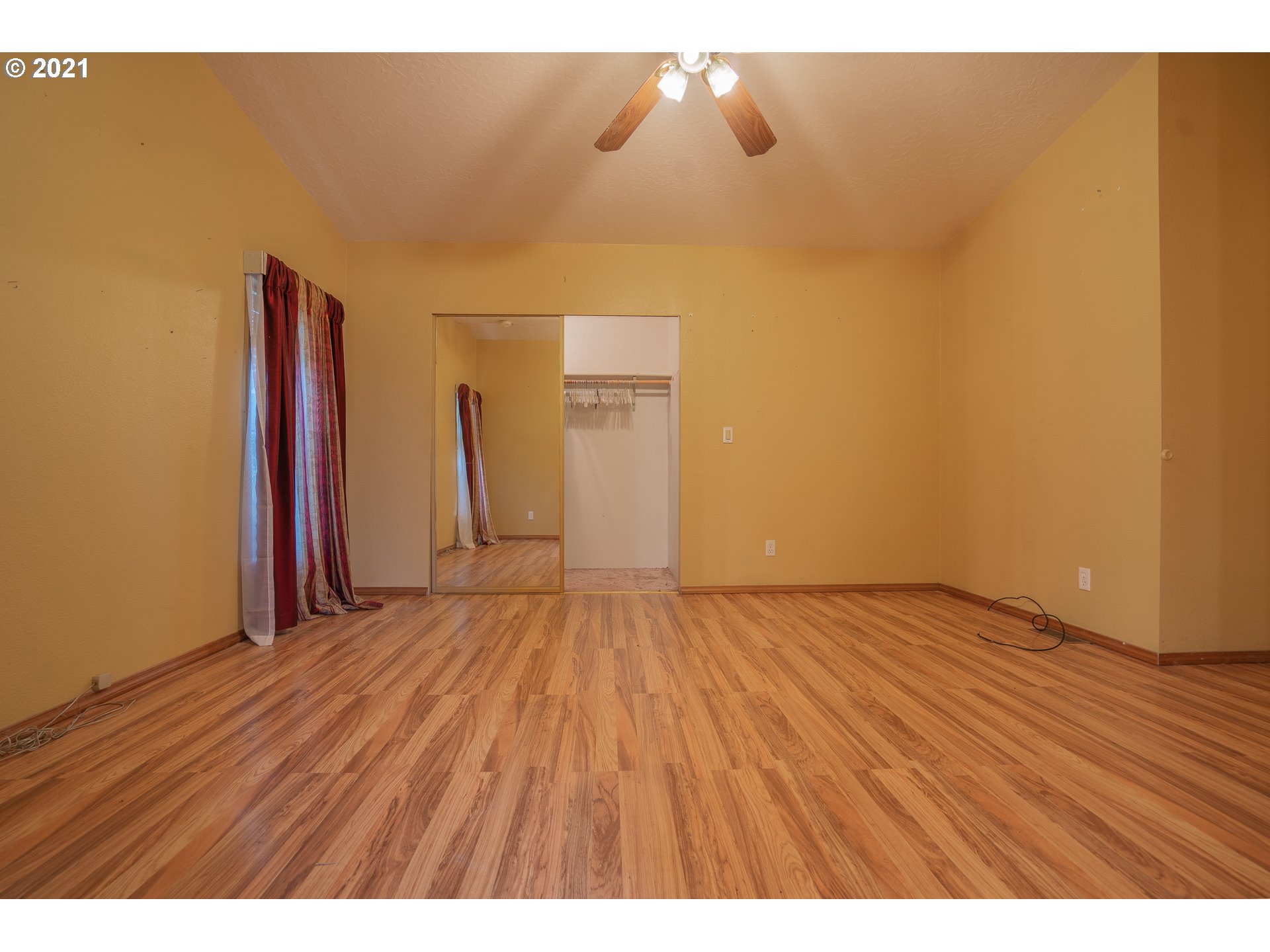 696 Applegate Avenue Yoncalla, OR 97499 - Photo 8 of 19 a view of an empty room with wooden floor