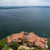 an aerial view of a house with lake view