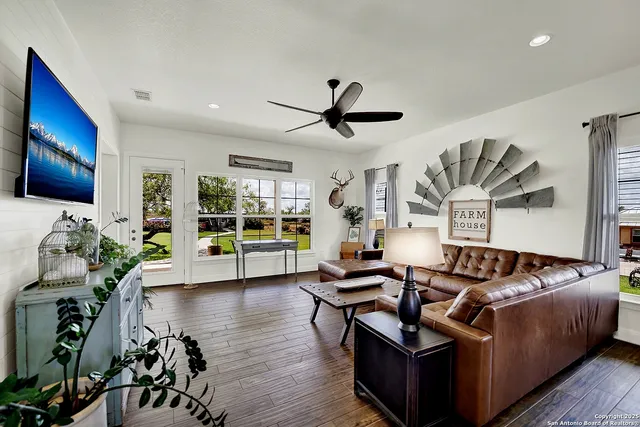 a living room with furniture bathtub and a flat screen tv