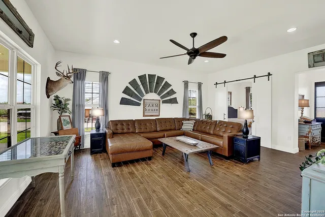 a living room with furniture and a wooden floor