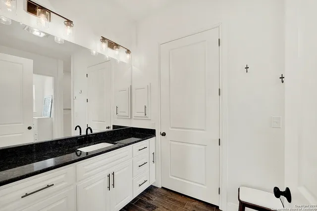 a view of a kitchen with white cabinets