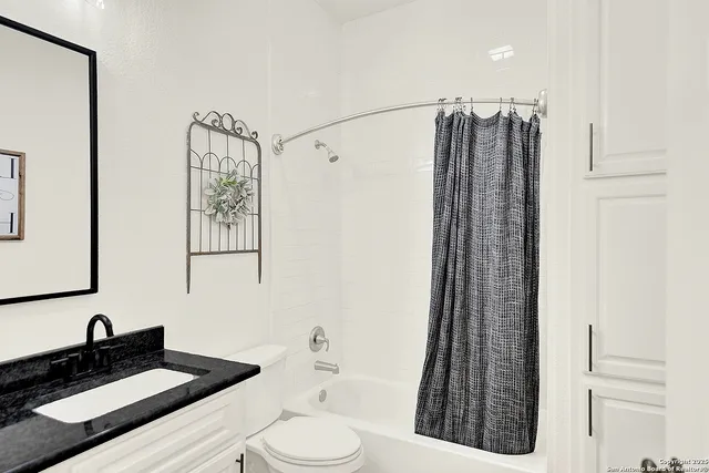 a view of a bedroom with furniture and book shelf