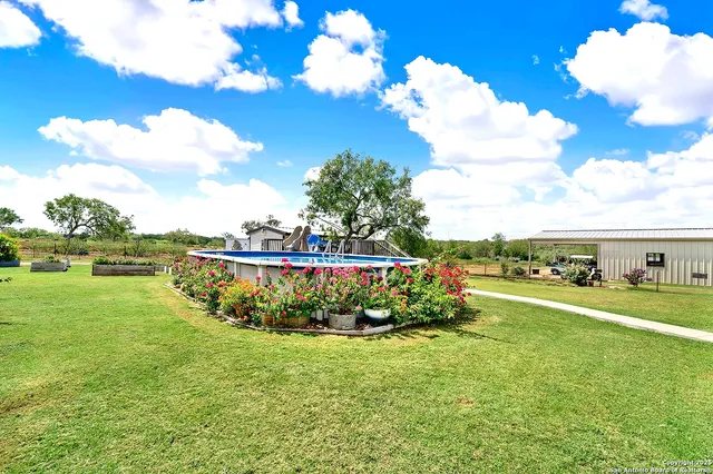 a view of a house with backyard and a play ground