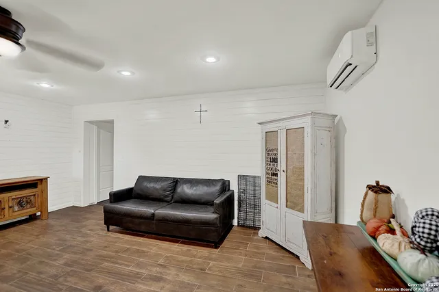 an empty room with a wooden floor and windows