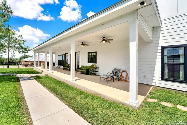 a view of house with backyard porch and outdoor seating