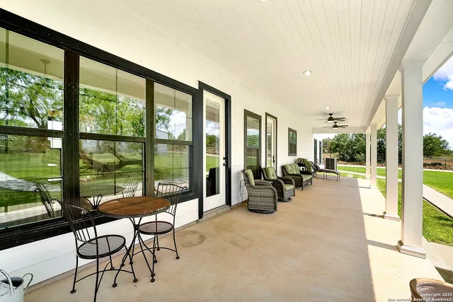 a living room with furniture and floor to ceiling windows