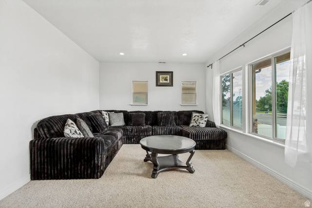 1585 South 910 West Payson, UT 84651 - Photo 4 of 32 Living area featuring recessed lighting, light-toned carpeting, and a wall of windows