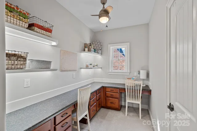 a bedroom with a bed a ceiling fan and a window