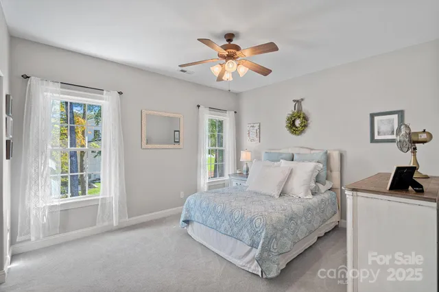 a bathroom with a sink vanity mirror and toilet