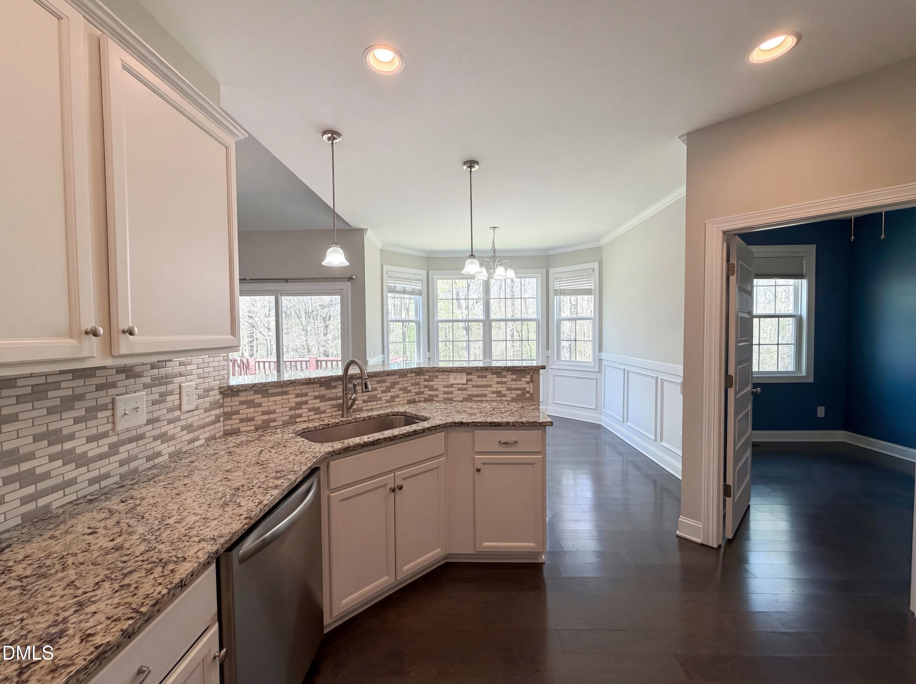 987 Red Stone Court Rougemont, NC 27572 - Photo 5 of 14 a kitchen with stainless steel appliances granite countertop a sink and dishwasher with wooden floor