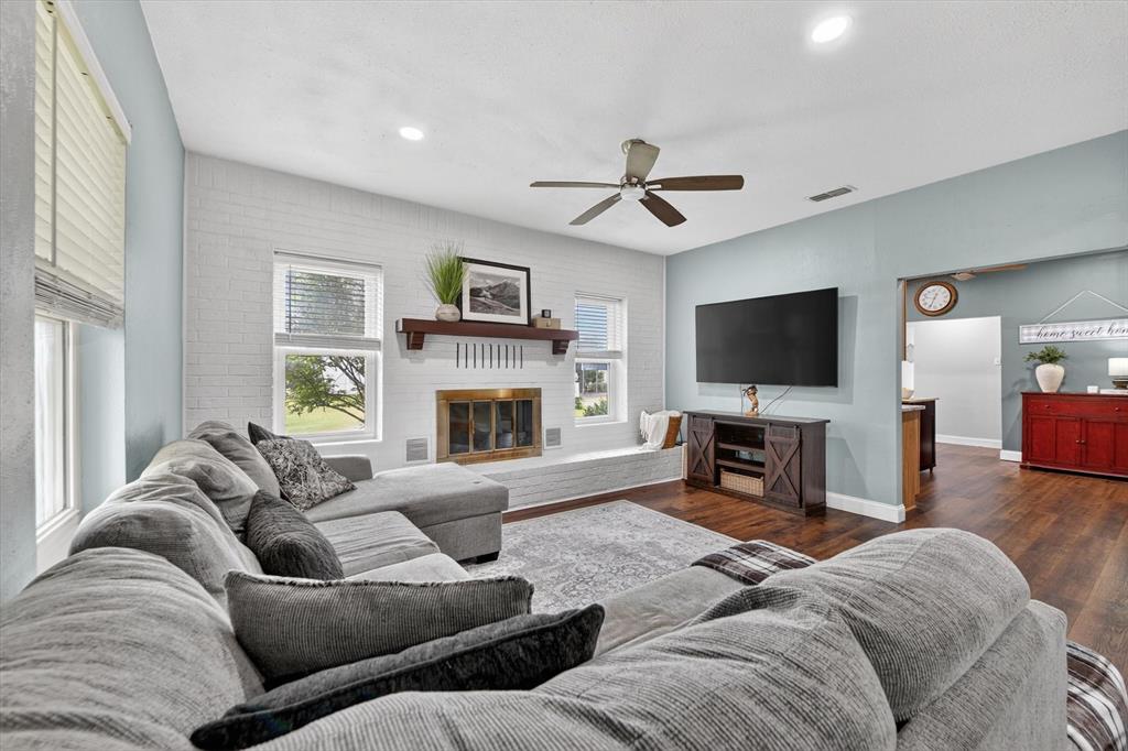 1808 Silver Creek Azle Road Azle, TX 76020 - Photo 9 of 32 a living room with furniture a fireplace and a flat screen tv