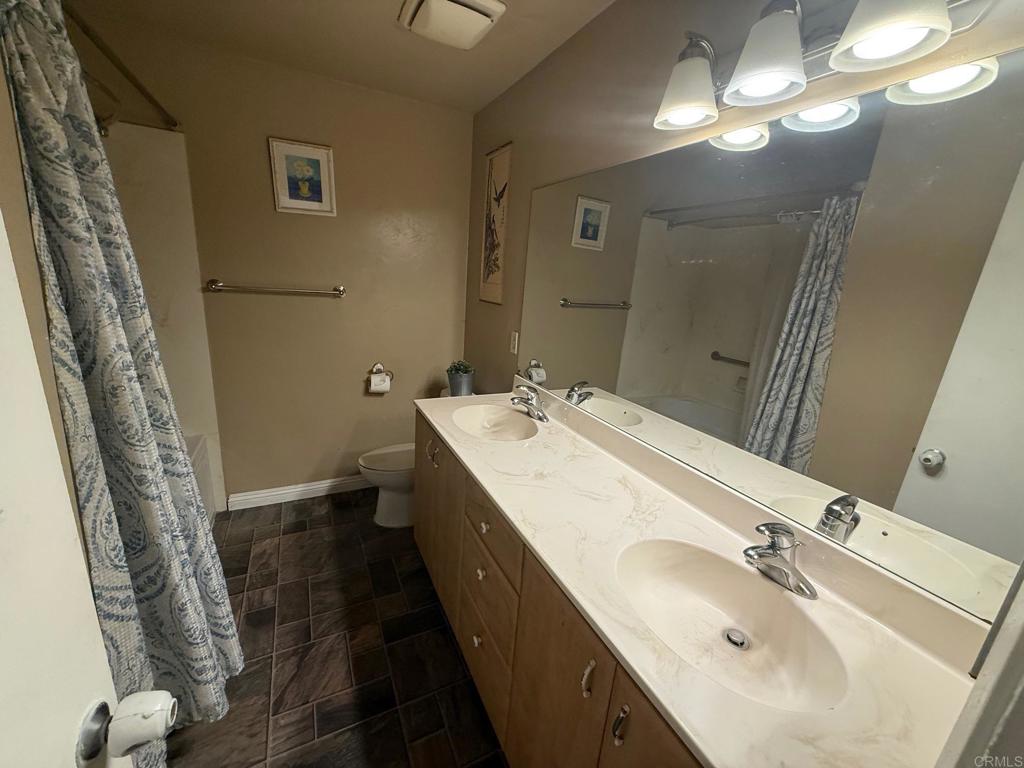 525 Shady Lane, Unit D El Cajon, CA 92021 - Photo 12 of 41 a bathroom with a double vanity sink and a mirror