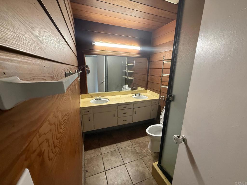 525 Shady Lane, Unit D El Cajon, CA 92021 - Photo 16 of 41 a bathroom with a sink a toilet and a mirror
