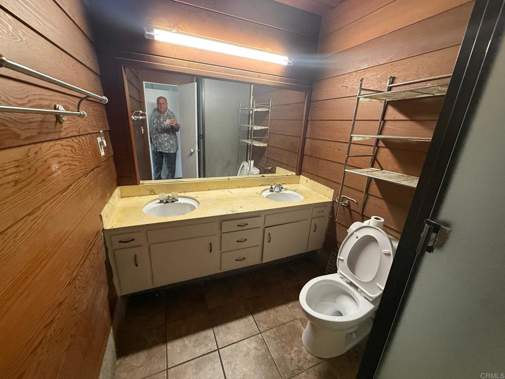 525 Shady Lane, Unit D El Cajon, CA 92021 - Photo 17 of 41 a bathroom with a granite countertop toilet sink and mirror
