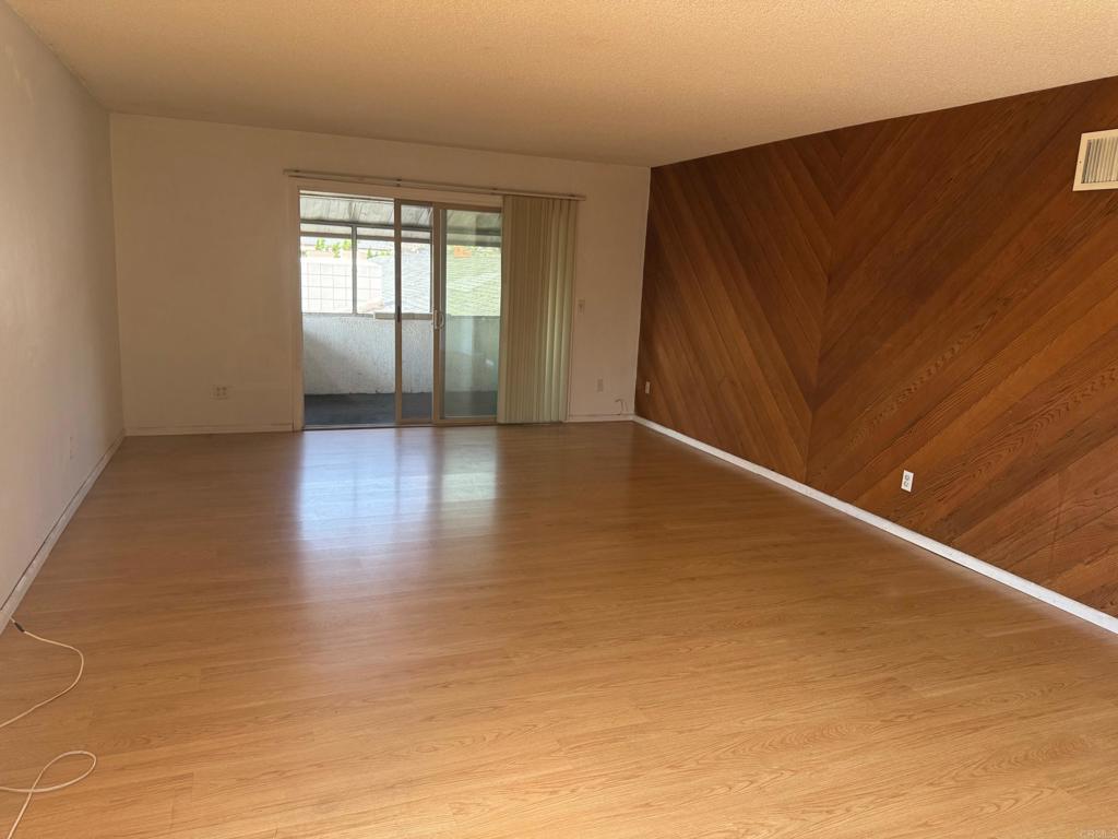 525 Shady Lane, Unit D El Cajon, CA 92021 - Photo 2 of 41 an empty room with wooden floor and windows