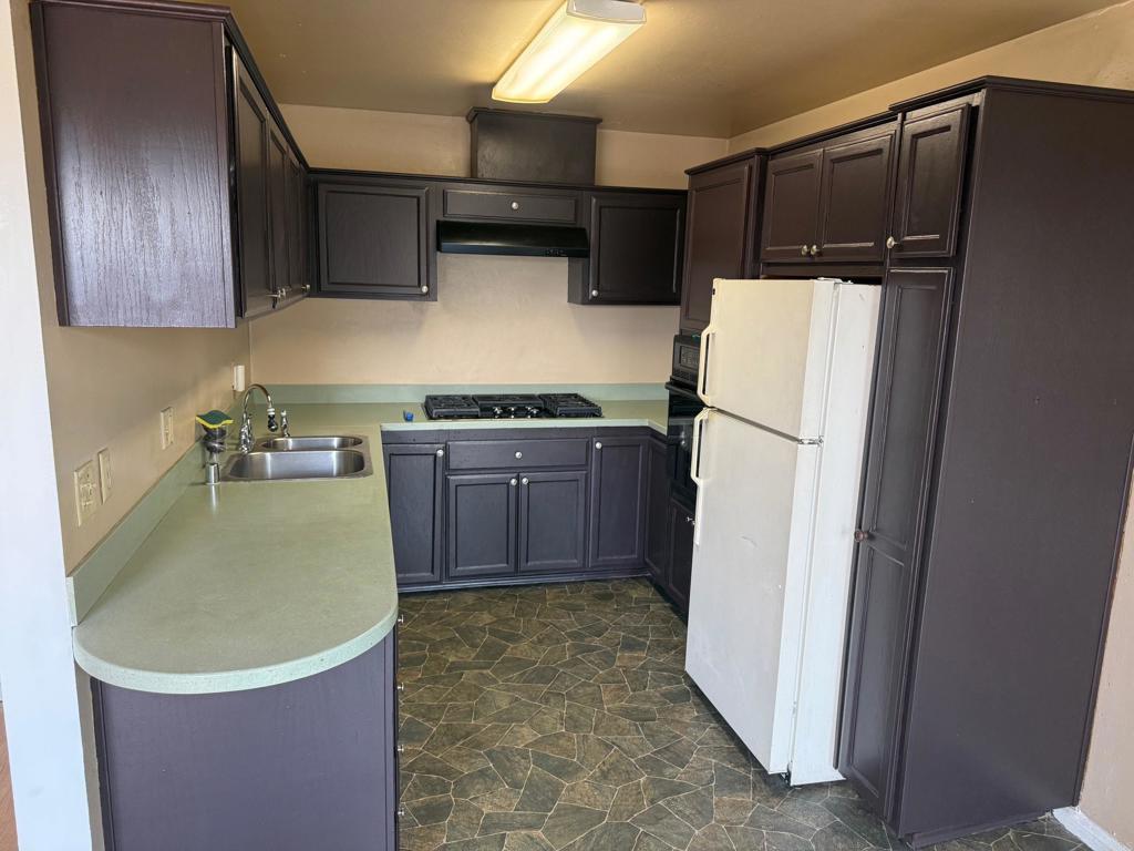 525 Shady Lane, Unit D El Cajon, CA 92021 - Photo 3 of 41 a kitchen with a refrigerator sink stove and cabinets