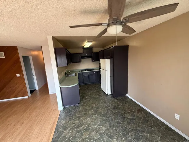 a kitchen with stainless steel appliances granite countertop a sink and a stove top oven