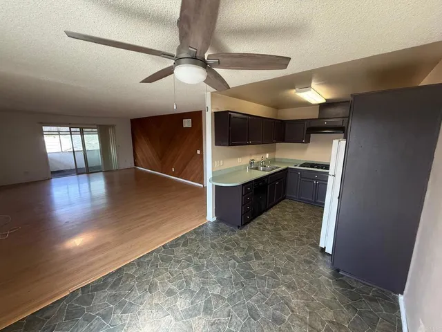 a view of a kitchen with a sink and cabinets