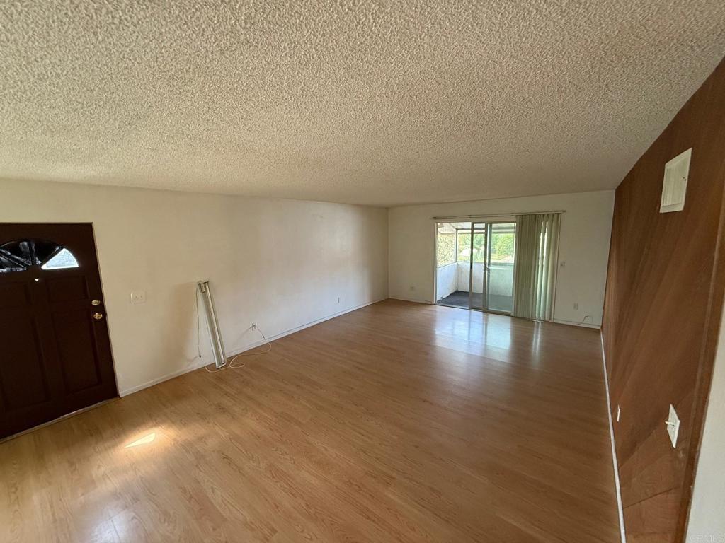 525 Shady Lane, Unit D El Cajon, CA 92021 - Photo 7 of 41 a view of empty room with wooden floor and fan