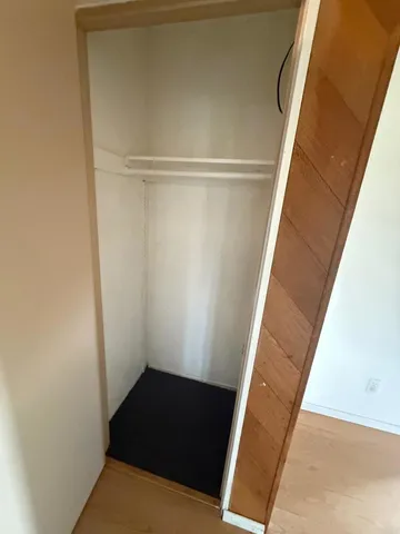 a spacious bathroom with a double vanity sink a toilet and a mirror