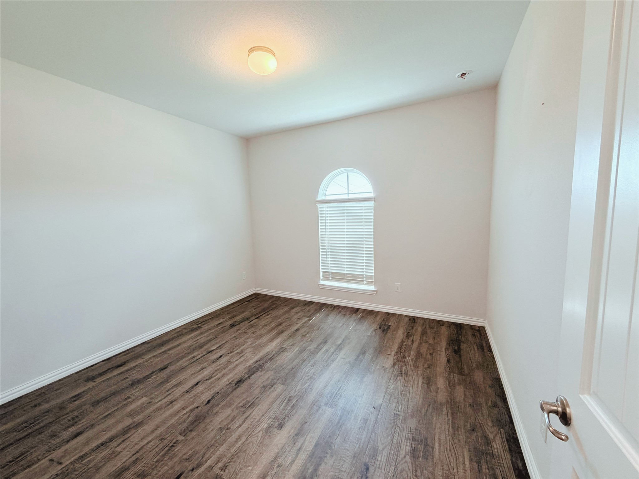 870 5102nd Road Cleveland, TX 77327 - Photo 13 of 27 an empty room with wooden floor and windows
