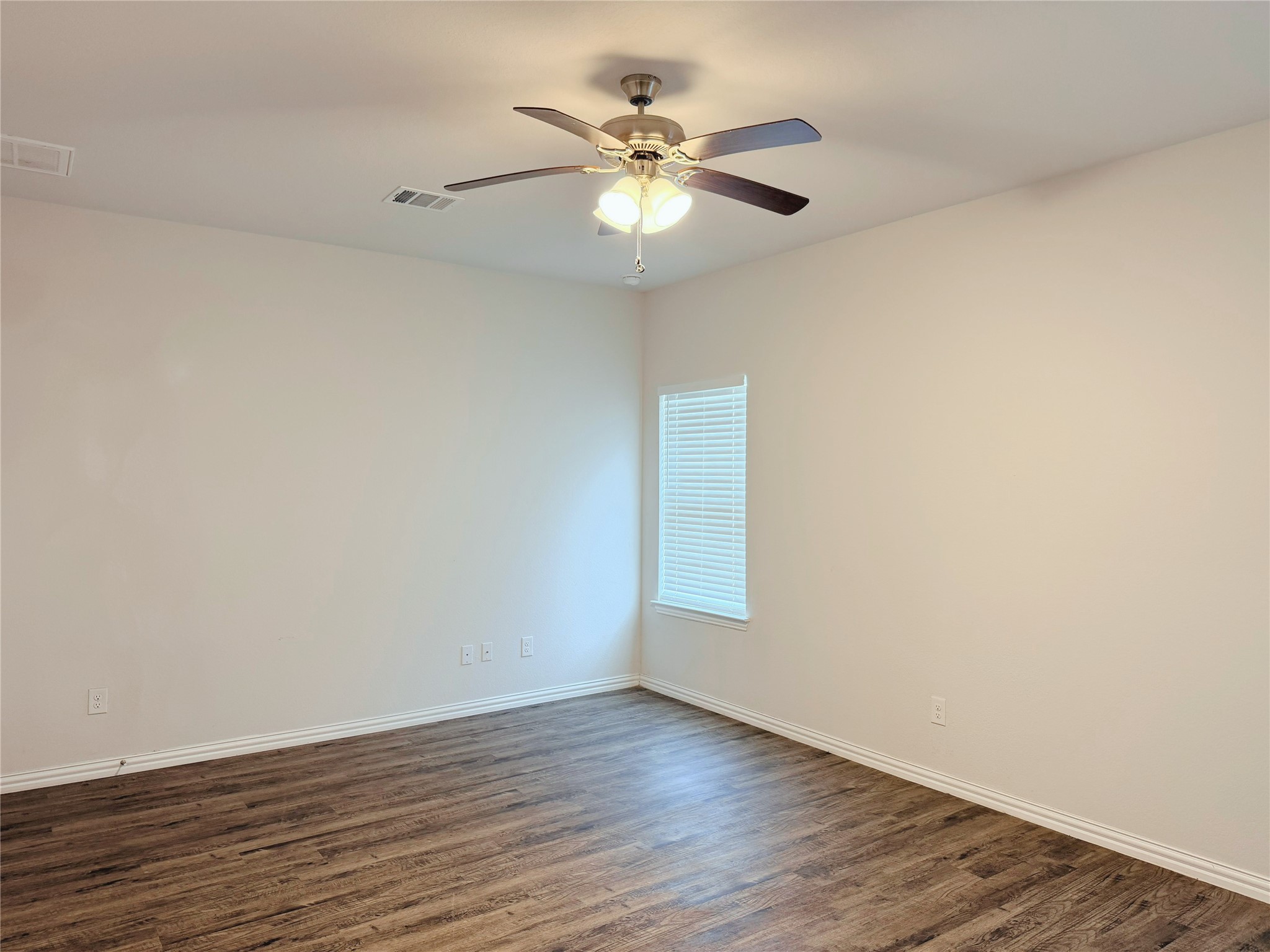 870 5102nd Road Cleveland, TX 77327 - Photo 18 of 27 a view of an empty room with wooden floor