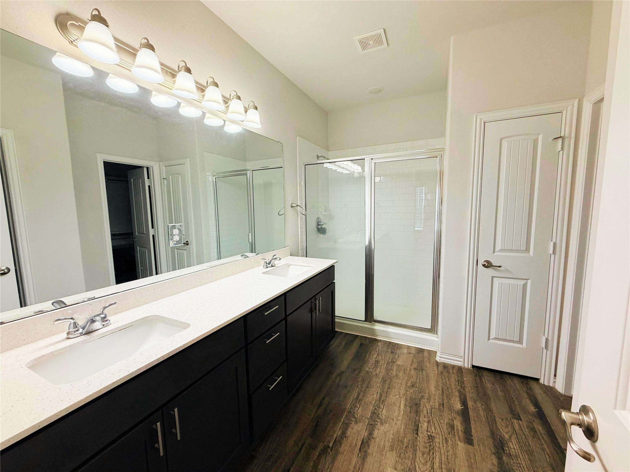 870 5102nd Road Cleveland, TX 77327 - Photo 21 of 27 a spacious bathroom with a double vanity sink a large mirror and shower view