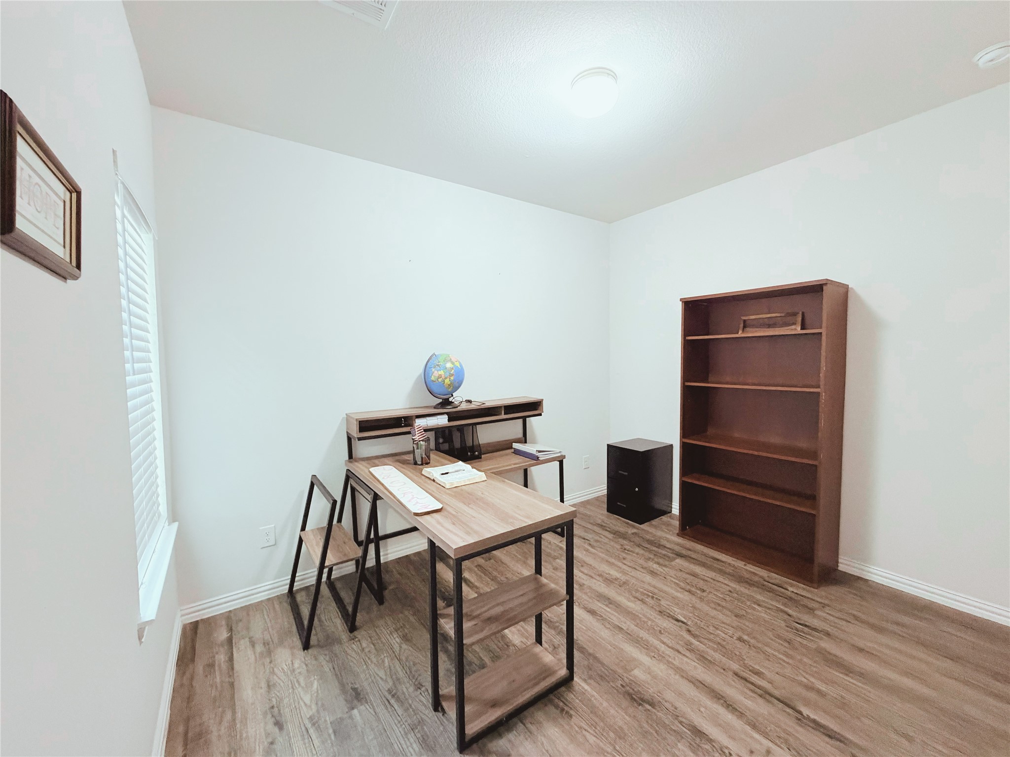 870 5102nd Road Cleveland, TX 77327 - Photo 22 of 27 a view of a workspace with furniture and wooden floor